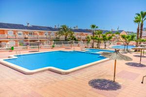 a large swimming pool in front of a building at Bungalow Carabassi Mediterraneo 3 Pool and roof terrace in Puerto Marino