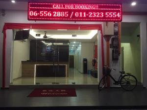 a bike parked in front of a store window at Hotel Alor Gajah in Malacca