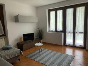 a living room with a couch and a table at La casa delle Sante in Capo di Ponte