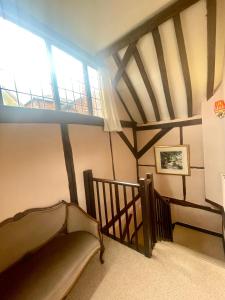 a attic room with a staircase and a window at The Coach House in Henley on Thames