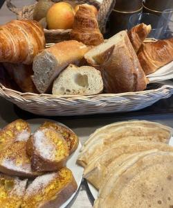 a table topped with two baskets of bread and pastries at Mas Belvega in La Baume-de-Transit +18 photos