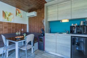 a kitchen with a table and chairs in a room at Rooftop Home With Whirlpool & Sauna - Happy Rentals in Trebnje