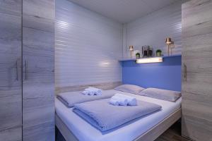 a bedroom with a bed with two towels on it at Rooftop Home With Whirlpool & Sauna - Happy Rentals in Trebnje