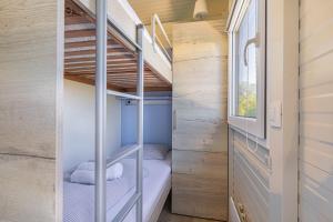 a small bedroom with bunk beds in a tiny house at Rooftop Home With Whirlpool & Sauna - Happy Rentals in Trebnje +15 photos