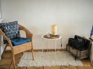 a wicker chair and a table in a room at Casa Frasca in Teguise