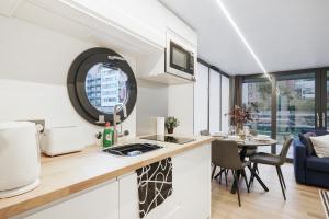 a kitchen and living room with a table and chairs at Water Lodge in London - Roof Terrace in London