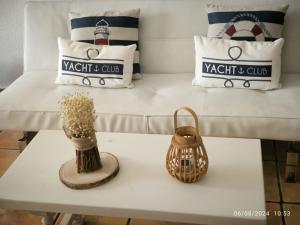 a white coffee table with a couch and pillows at Casa Frasca in Teguise