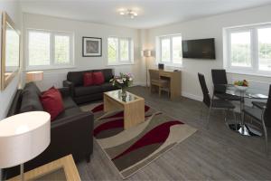 a living room with a couch and a table at House of Fisher - Beneficial House in Bracknell