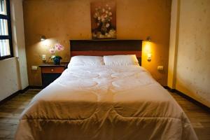 Postel nebo postele na pokoji v ubytování Hostal Cielo