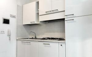 a white kitchen with white cabinets and a sink at Casa Sant Elena ID15675 in Peschiera del Garda