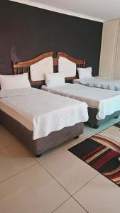 Uma cama ou camas num quarto em Goodlife guest house in klerksdorp