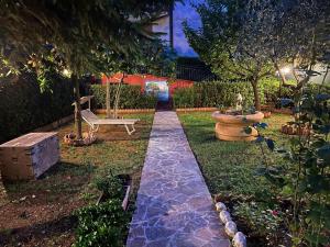 a garden with a swing and a bench in a yard at Buonarroti 19 in Pesaro