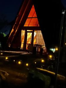 a room with a large window with lights in it at Casa de poveste A Frame in Gura Humorului