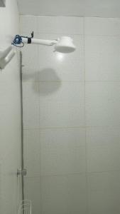 a shower with a glass door with a light on it at Mini Apartamento en Casa San Martin in Tarapoto +3 photos