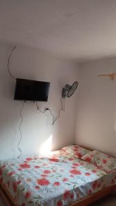 a bedroom with a bed with a phone on the wall at Mini Apartamento en Casa San Martin in Tarapoto