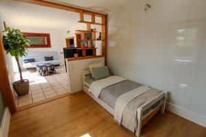 a bedroom with a bed and a living room at Charmante Maison avec Terrasse in Saint-Vallier +2 photos