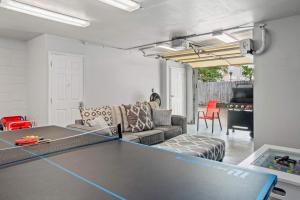 a living room with a ping pong table at Dest-Zen Gated Beach Access Game Room in Destin