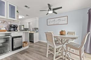 a kitchen and dining room with a table and chairs at Dest-Zen Gated Beach Access Game Room in Destin