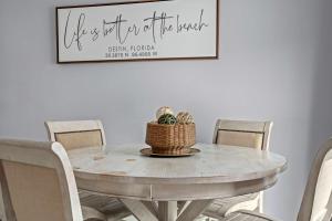 a dining room table with chairs and a picture on the wall at Dest-Zen Gated Beach Access Game Room in Destin +49 photos
