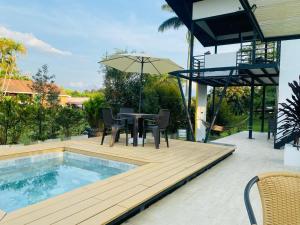 a patio with a table and chairs next to a pool at GatoPardo in Montenegro