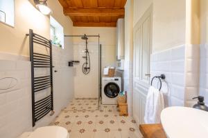 a bathroom with a washing machine in the shower at Carpe diem Vendégház in Cserépfalu +56 photos
