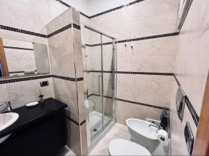 a bathroom with a shower and a toilet and a sink at Best Stay - Central Station Suite Apartments in Bari +15 photos