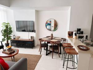 a kitchen and living room with a table and chairs at Modern City Condo El Millon in El Jobo de Mendoza