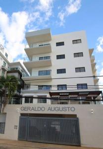 a tall white building with a gate in front of it at Modern City Condo El Millon in El Jobo de Mendoza