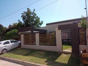 a house with a car parked in front of it at Aquinini in San José