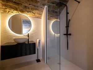 a bathroom with a sink and a mirror at La Bodega de Casa La Esencia in Aínsa +18 photos