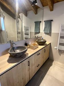 a bathroom with two sinks on a wooden counter at Chalet en la Cerdanya in Latour-de-Carol