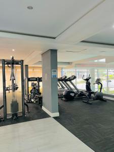 a gym with treadmills and exercise equipment in a building at Urban Park K001, Umhlanga Rocks in Durban
