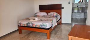Llit o llits en una habitació de Hotel Rivera
