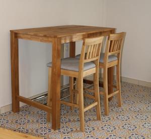 a wooden table with two chairs and a table at Molinero in Vejer de la Frontera