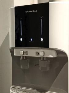 a toaster oven with a box on top of it at Good2Stay Budget Hotel l Lift l Coway Water l WIFI6 l Laundromat in Malacca