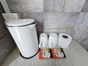 a bathroom with a toilet and two rolls of toilet paper at Good2Stay Budget Hotel l Lift l Coway Water l WIFI6 l Laundromat in Malacca +25 photos