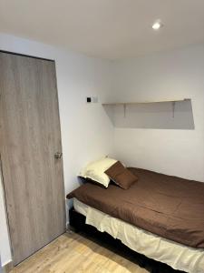 a small bedroom with a bed and a closet at Habitaciones tipo hotel con terraza in Ibagué +44 photos
