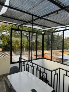 a room with tables and chairs and windows at Habitaciones tipo hotel con terraza in Ibagué