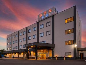 a building with a clock on top of it at Hotel Nami in Kumano