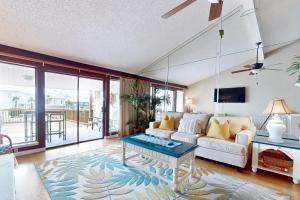 a living room with a couch and a table at Mapp to Paradise in Destin