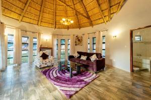 a living room with a couch and a table at Peniel Retreat Centre in Victoria Falls