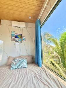a bed in a room with a large window at Homestay Vitamin SEA - View Biển Phú Quý in Cu Lao Thu +49 photos
