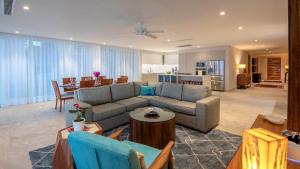 a living room with a couch and a dining room at 4 BR Casa Indah is a Gorgeous New 3400 SF Condo in Puerto Vallarta