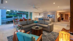 a living room with a couch and a dining room at 4 BR Casa Indah is a Gorgeous New 3400 SF Condo in Puerto Vallarta