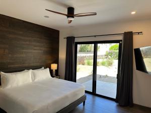 a bedroom with a bed and a sliding glass door at Casa Santos Pedregal in Cabo San Lucas +32 photos