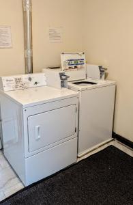 a room with a stove and a washer and dryer at Spacious Downtown 2-bdrm Apartment in Anchorage