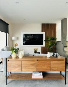 a living room with a large wooden dresser at Habitación Doble in Morelia