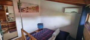 a small room with a bed and a picture on the wall at Morada Vó Rita in Florianópolis