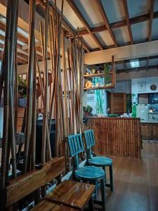 a restaurant with two chairs and surfboards on the wall at House of Bela in Iloilo City