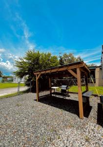 a wooden pavilion with a bench in a park at Costa Del Encanto Camper RV in Betances